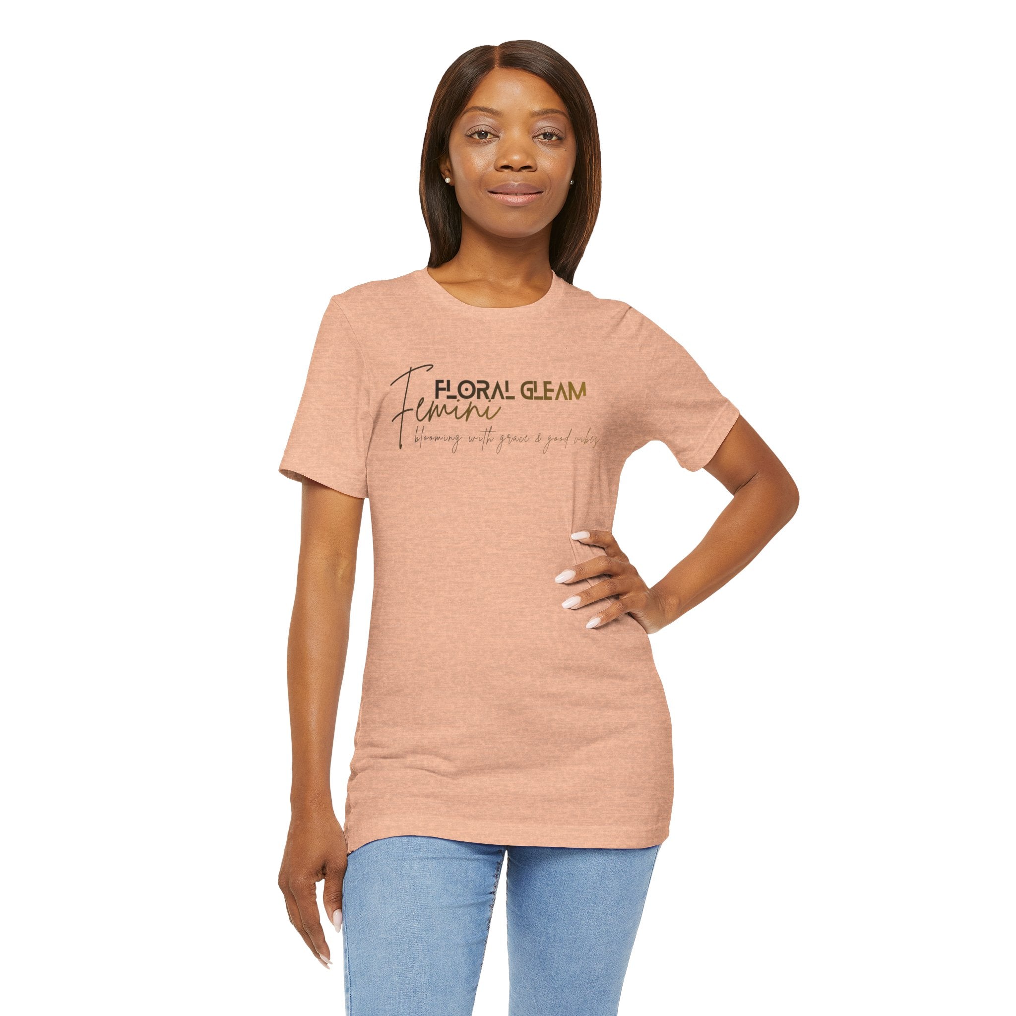 Woman wearing a peach t-shirt with 'rooted.' text on a white background