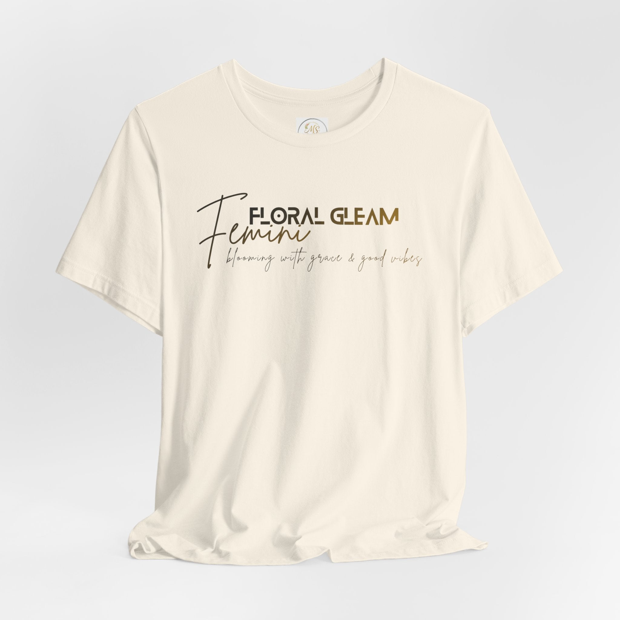 Beige t-shirt with 'Floral Gleam Feminine' text on a light gray background